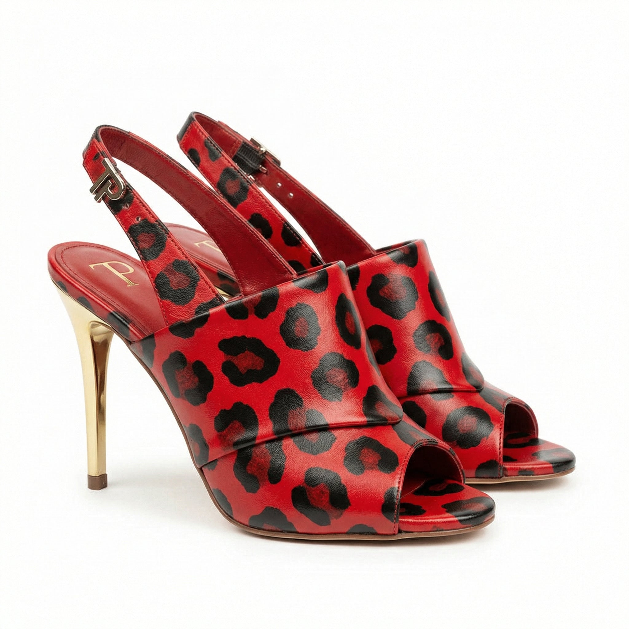 Red high-heeled shoes with black leopard print design on a white background