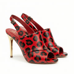 Red high-heeled shoes with black leopard print design on a white background