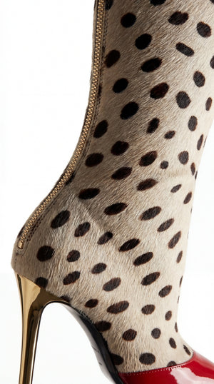 Close-up of a boot with a spotted pattern and red accents