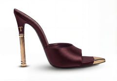 Maroon high-heeled shoe with gold accents on a white background